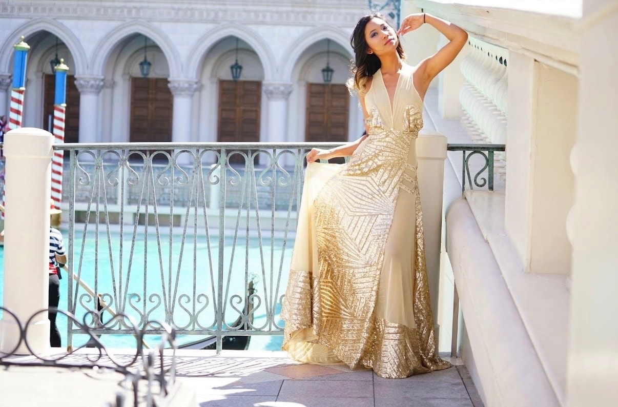 Gold sequin ballgown on balcony